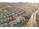 Panoramic aerial view of a desert community with stylish homes, mountain views, and convenient road access at 14 Parco Fiore Ct, Henderson, NV 89011