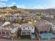 Beautiful backyard features a patio, manicured lawn, seating area, and in-ground pool at 14 Parco Fiore Ct, Henderson, NV 89011