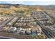 Expansive aerial view of a desert neighborhood with golf course, mountain backdrop, and modern home designs at 14 Parco Fiore Ct, Henderson, NV 89011