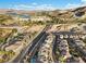 Scenic aerial view of homes in a desert neighborhood near a golf course, lake, and mountain landscape at 14 Parco Fiore Ct, Henderson, NV 89011