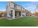 Large backyard features a covered patio, artificial grass, and outdoor seating for perfect outdoor enjoyment at 14 Parco Fiore Ct, Henderson, NV 89011
