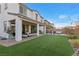 Expansive backyard features a covered patio, artificial grass, and outdoor seating area for relaxation at 14 Parco Fiore Ct, Henderson, NV 89011