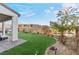 Well-maintained backyard featuring artificial turf, desert landscaping, and a covered patio area at 14 Parco Fiore Ct, Henderson, NV 89011