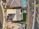 Aerial perspective of a backyard featuring a pool, cozy patio, and well-manicured lawn at 14 Parco Fiore Ct, Henderson, NV 89011