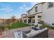 Charming backyard with a patio, fire pit, lush lawn, and covered outdoor seating area at 14 Parco Fiore Ct, Henderson, NV 89011