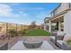 Outdoor patio with a modern fire pit, comfortable seating, and a lush green lawn at 14 Parco Fiore Ct, Henderson, NV 89011
