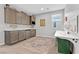 Versatile bonus room featuring a sink, mini-fridge, built-in cabinets, and ample space for various activities at 14 Parco Fiore Ct, Henderson, NV 89011