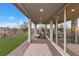 Spacious covered patio with brick flooring, outdoor seating, and sliding glass doors at 14 Parco Fiore Ct, Henderson, NV 89011