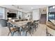 Large dining table in a bright, open space connecting to living area and kitchen at 14 Parco Fiore Ct, Henderson, NV 89011