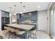 Stylish kitchen boasts gray cabinets, granite countertops, stainless steel appliances, and a large island with seating at 14 Parco Fiore Ct, Henderson, NV 89011