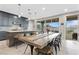 Open kitchen features a spacious island, modern appliances, and a dining area with access to the outdoor space at 14 Parco Fiore Ct, Henderson, NV 89011