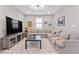 Cozy living room with a large sectional sofa, a TV, and a playful atmosphere at 14 Parco Fiore Ct, Henderson, NV 89011