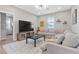 Comfortable living room with a large television, sectional sofa, and neutral color scheme at 14 Parco Fiore Ct, Henderson, NV 89011