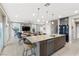 Open-concept living space with a kitchen island, dining area, and comfortable living room with abundant natural light at 14 Parco Fiore Ct, Henderson, NV 89011