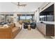 Stylish living room with a modern ceiling fan, cozy seating, and sliding glass doors at 14 Parco Fiore Ct, Henderson, NV 89011