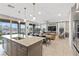 Bright living space featuring an open layout, a kitchen island, and a dining area with sliding doors to the backyard at 14 Parco Fiore Ct, Henderson, NV 89011