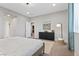 Well-lit primary bedroom with bed, carpet, and ensuite bathroom at 14 Parco Fiore Ct, Henderson, NV 89011