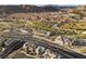 An aerial view showing the community, streets, desert landscaping, and beautiful mountain scenery at 14 Parco Fiore Ct, Henderson, NV 89011