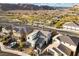 Attractive two-story homes situated near streets and desert landscaping with a mountain backdrop at 14 Parco Fiore Ct, Henderson, NV 89011