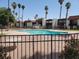 Community pool with a black metal fence and surrounding desert landscaping at 1405 Vegas Valley Dr # 270, Las Vegas, NV 89169