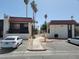 Street view of stucco-sided units with parking, desert landscaping, and tile roofing at 1405 Vegas Valley Dr # 270, Las Vegas, NV 89169