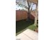 A cozy backyard with artificial turf, a concrete patio, and a young tree at 1423 Orange Jubilee Rd, Henderson, NV 89014
