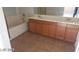 Bathroom with double sink vanity, bathtub with neutral tile flooring at 1423 Orange Jubilee Rd, Henderson, NV 89014