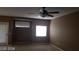 Spacious bedroom featuring neutral carpet, a ceiling fan, and natural light from large windows at 1423 Orange Jubilee Rd, Henderson, NV 89014