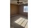 Bright bedroom with ceiling fan, large window, and carpeted floor at 1423 Orange Jubilee Rd, Henderson, NV 89014