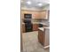 Bright kitchen with black appliances, granite countertops, and tile flooring at 1423 Orange Jubilee Rd, Henderson, NV 89014