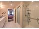 Modern bathroom featuring white marble floors, shower with chrome fixtures and an ensuite bedroom at 150 Las Vegas Blvd # 1912, Las Vegas, NV 89101