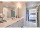 Modern bathroom with vanity, large mirror, and a view into the bedroom at 150 Las Vegas Blvd # 1912, Las Vegas, NV 89101