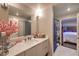 Bathroom with modern vanity, sink, mirror, and a pink flower arrangement on the counter at 150 Las Vegas Blvd # 1912, Las Vegas, NV 89101