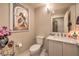 Bathroom with vanity, sink, mirror, commode, and decorative prints on the wall at 150 Las Vegas Blvd # 1912, Las Vegas, NV 89101