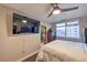 Bedroom features a modern ceiling fan, hard wood floors, dresser, and a large window with a city view at 150 Las Vegas Blvd # 1912, Las Vegas, NV 89101