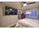 Bedroom features a modern ceiling fan, hard wood floors, dresser, and a large window with a city view at 150 Las Vegas Blvd # 1912, Las Vegas, NV 89101