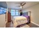 Bedroom features hardwood floors, dresser, a ceiling fan and large picture windows with views of the city at 150 Las Vegas Blvd # 1912, Las Vegas, NV 89101