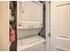 Stacked washer and dryer in a laundry closet with storage shelves and detergent at 150 Las Vegas Blvd # 1912, Las Vegas, NV 89101