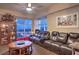 Comfortable living room with a leather couch, hardwood floors, and large windows showcasing city and mountain views at 150 Las Vegas Blvd # 1912, Las Vegas, NV 89101