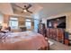 Spacious main bedroom with wooden furniture and ceiling fan, plus windows showcasing city views at 150 Las Vegas Blvd # 1912, Las Vegas, NV 89101