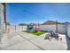 View of backyard with string lights, playhouse, artificial grass, and recreational equipment at 1714 Ringe Ln, Las Vegas, NV 89156