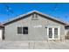 Rear exterior view of home showing clean gray siding, backyard patio, and access door at 1714 Ringe Ln, Las Vegas, NV 89156