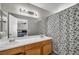 Bathroom with dual sinks, light wood vanity, and shower tub combination at 1714 Ringe Ln, Las Vegas, NV 89156