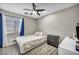 Comfortable bedroom with a window, wood-look floors, ceiling fan, and neutral colors at 1714 Ringe Ln, Las Vegas, NV 89156