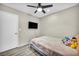 Bedroom with wood floors, ceiling fan and mounted flat screen television at 1714 Ringe Ln, Las Vegas, NV 89156
