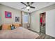 Bedroom with a full closet, ceiling fan, wood floors and window at 1714 Ringe Ln, Las Vegas, NV 89156