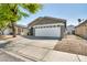 Inviting single-story home with a well-maintained front yard, long driveway and attached two-car garage at 1714 Ringe Ln, Las Vegas, NV 89156
