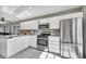 Bright kitchen showcasing white cabinets, stainless steel appliances, and marble countertops at 1714 Ringe Ln, Las Vegas, NV 89156