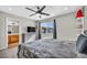 Main bedroom with a gray dresser, ceiling fan, dark wood floors, and window at 1714 Ringe Ln, Las Vegas, NV 89156