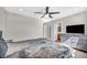 Main bedroom with a gray dresser, ceiling fan, dark wood floors, and ensuite bath at 1714 Ringe Ln, Las Vegas, NV 89156
